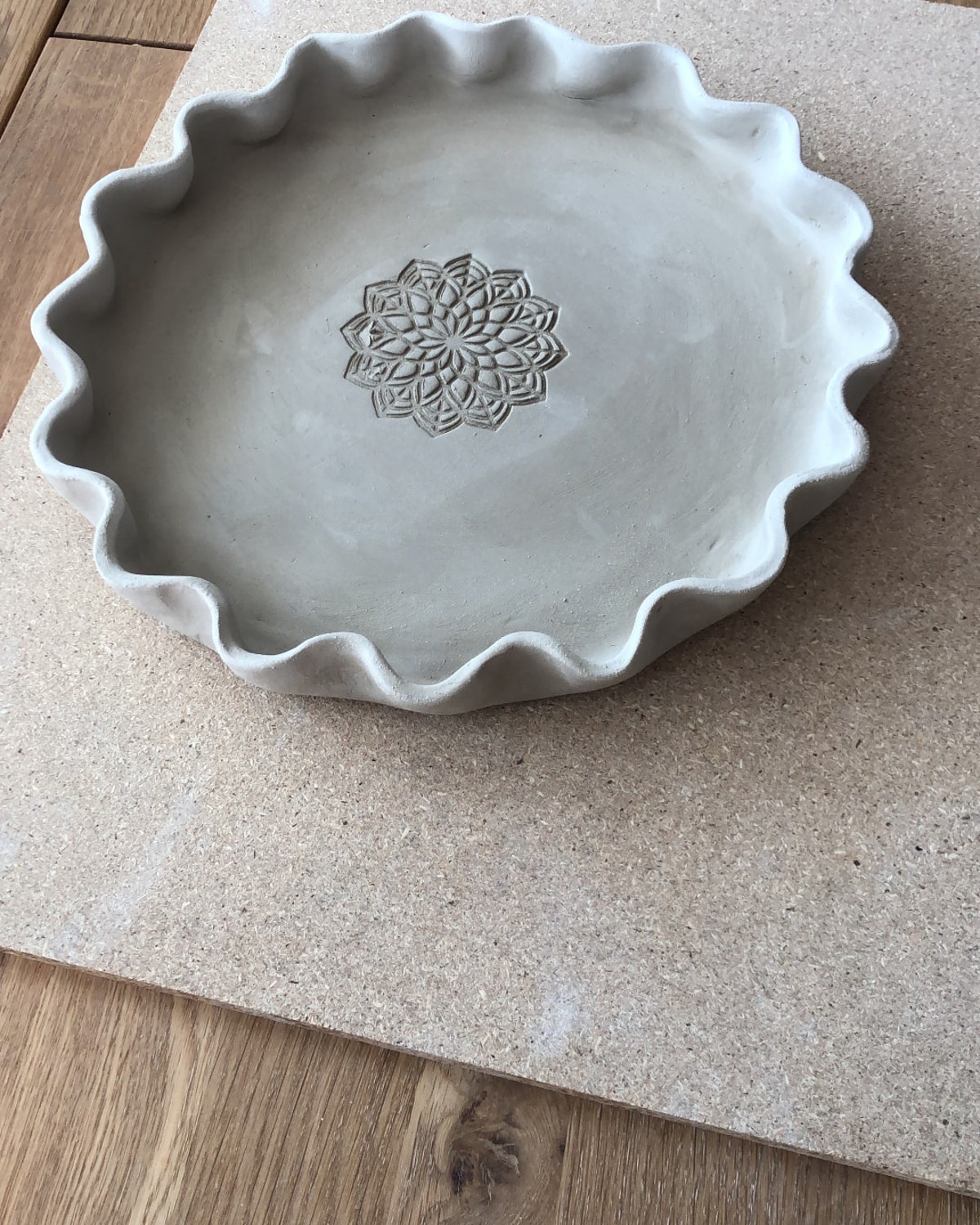 Teller mit Wellenrand und Mandala-Muster aus Ton